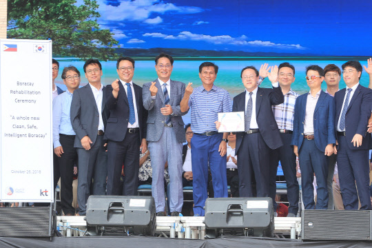 KT는 26일 필리핀 보라카이 칵반(Cagban) 항구 재개장 개소식에 참석해 '스마트 보라카이' 프로젝트를 선보였다. 김성인 KT 글로벌컨설팅 상무(왼쪽 여섯번째), 로이 시마투  필리핀 환경부 장관(다섯번째) 장관 등 주요 관계자들이 기념촬영을 하고 있다.  KT 제공